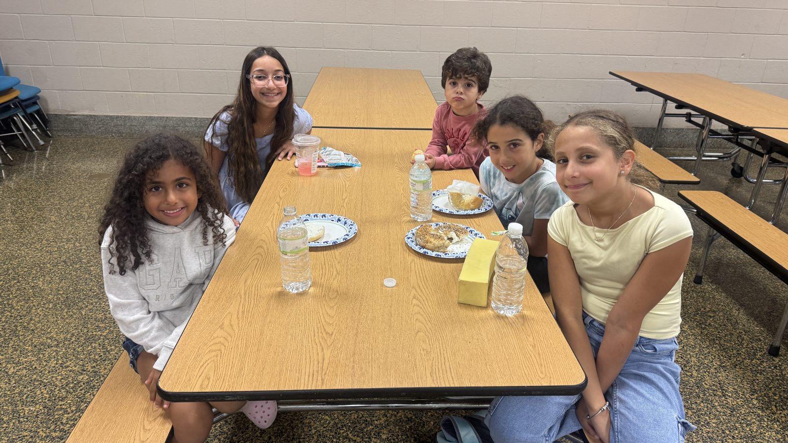 Young members of the fellowship gathered around a table sharing a meal